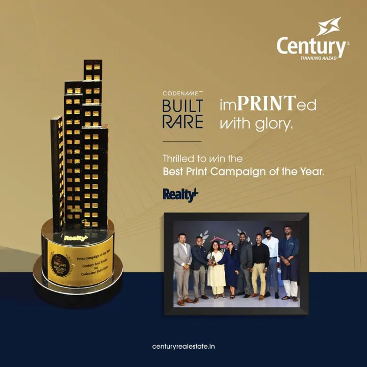 Century post: “Codename Built Rare — imPRINTed with glory”, with the Realty+ trophy and team photo.